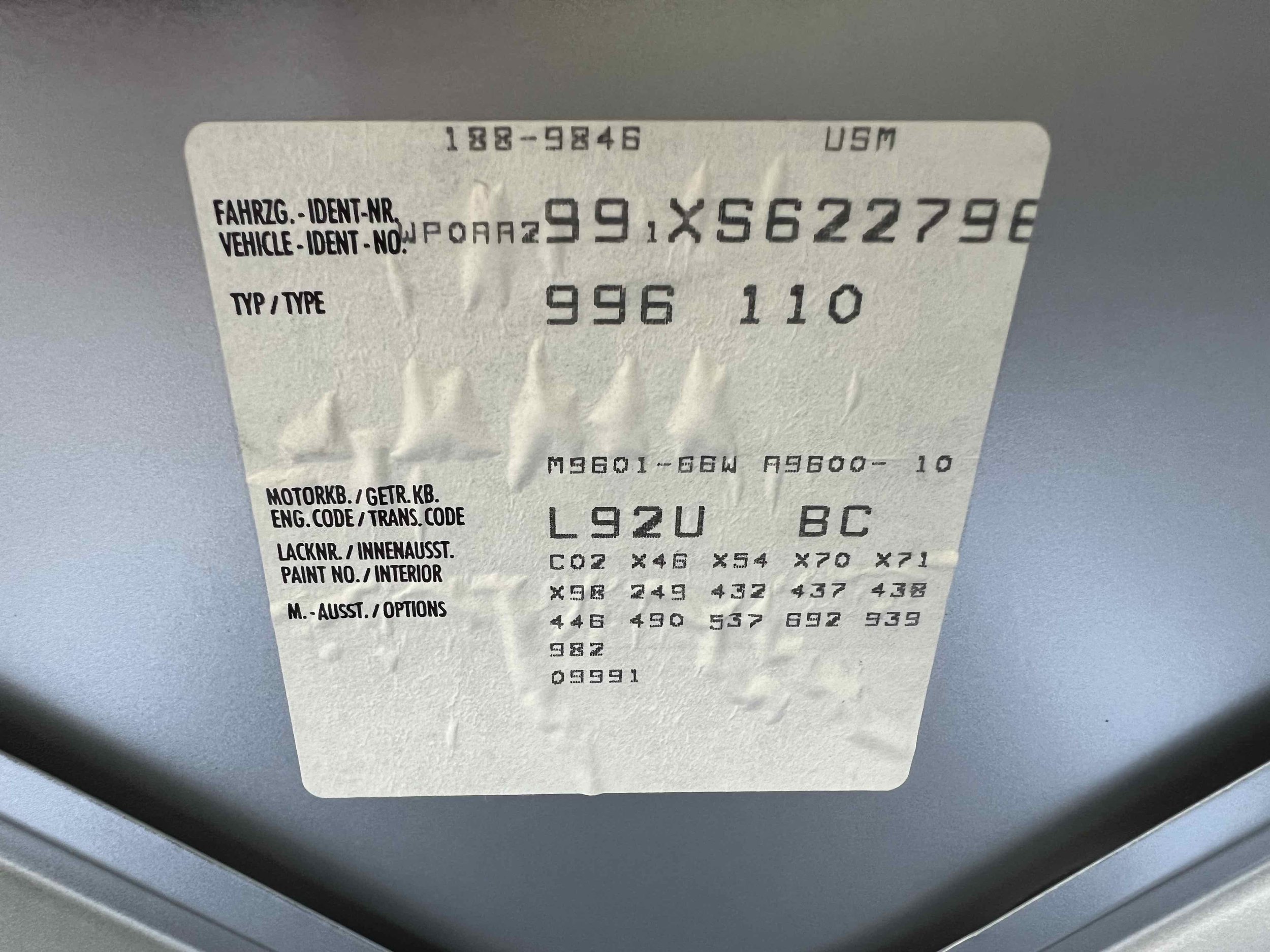 Vehicle information label with various codes, numbers, and labels for identification, color, and options.