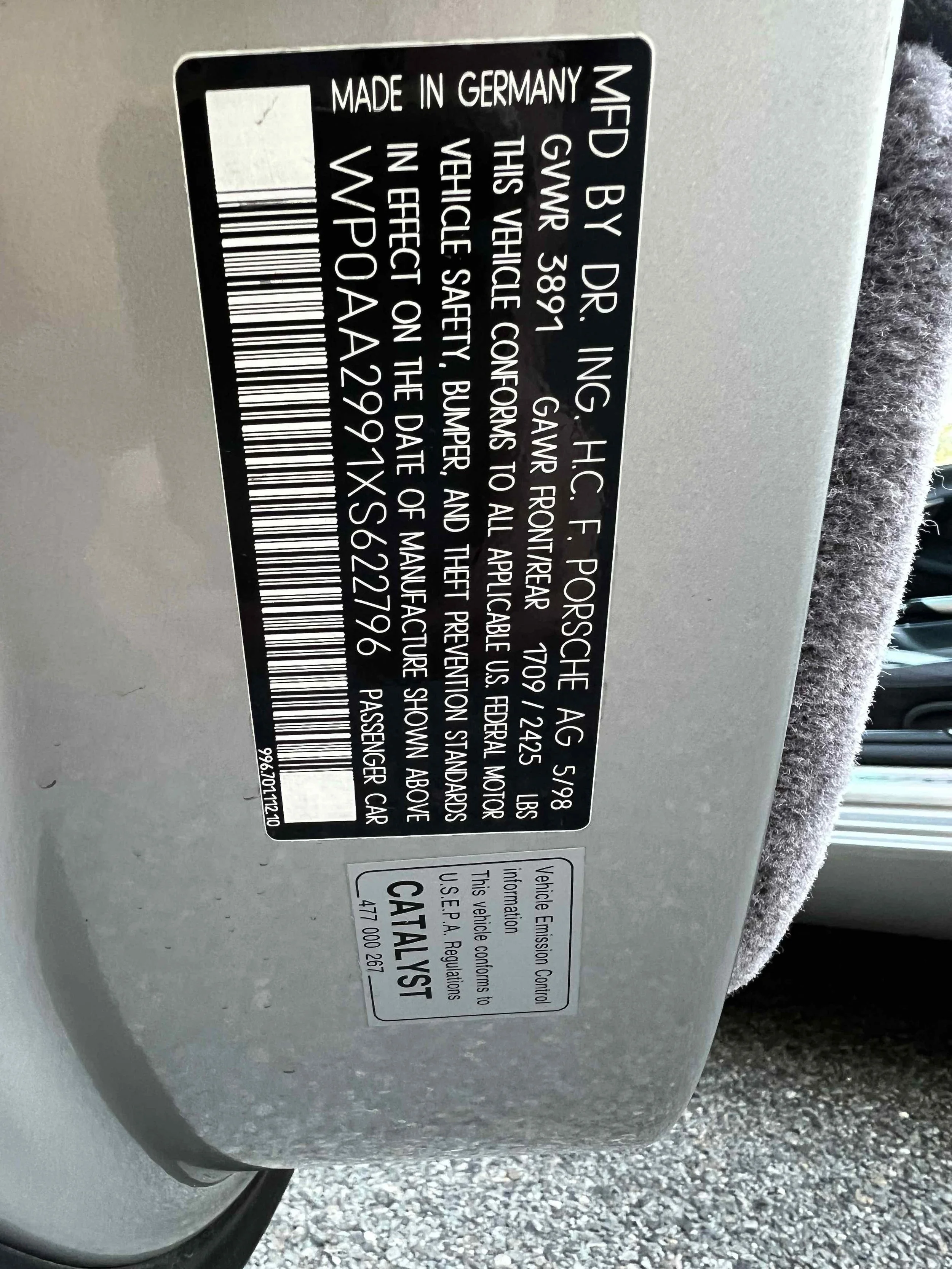 Vehicle information label showing that the vehicle was made in Germany by Dr. Ing. H.C. F. Porsche AG. The vehicle's GVWR is 3891 lbs, and the front and rear GAWR are 1709 lbs and 1245 lbs respectively. It includes a statement about compliance with s