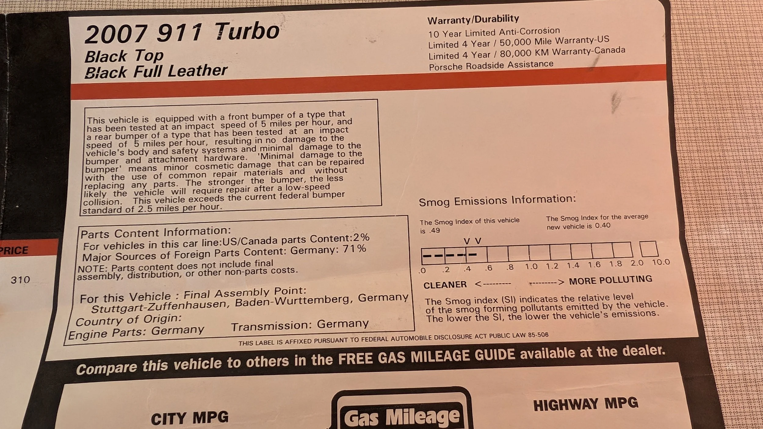 Label for a 2007 Porsche 911 Turbo with a black top and full black leather interior. The label provides vehicle details including warranty information, smog emissions rating, parts content, and assembly location in Germany.