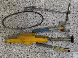 A Ferrari 512 BB tool kit on a garage floor.