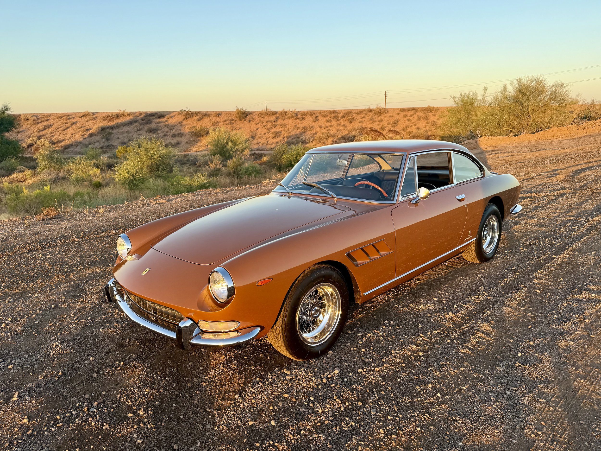 1967 Ferrari 330 GT Series II 2+2 on display near brick wall