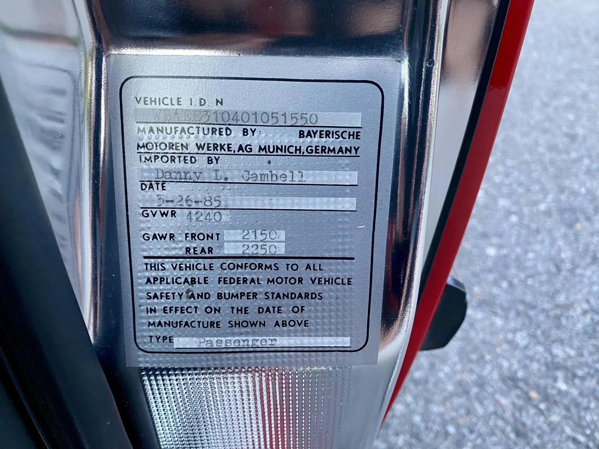 Close-up of a vehicle identification and specifications plate showing manufacture details, date, weight limits, and conformity statements.
