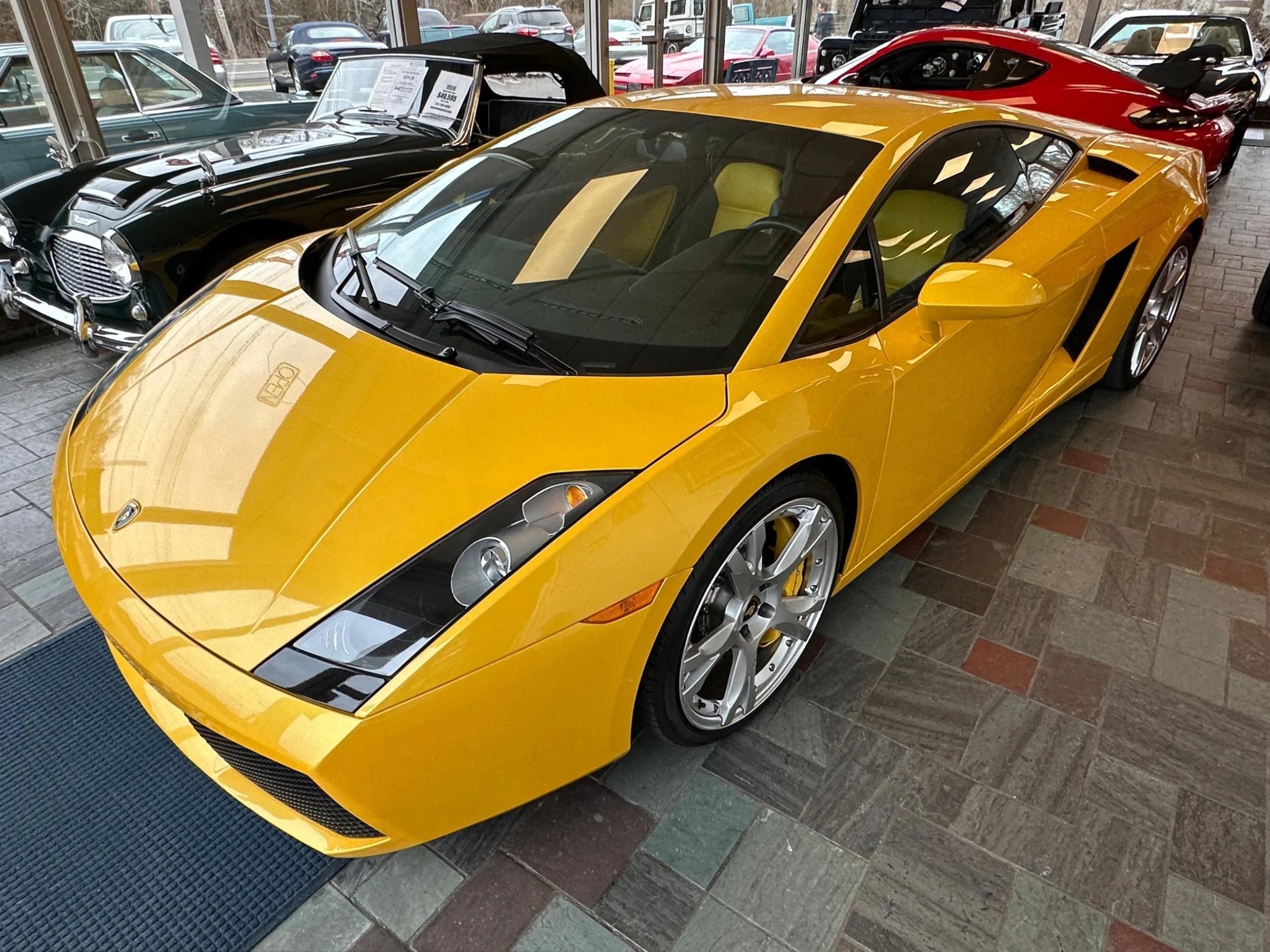 A yellow Lamborghini sports car inside a showroom.