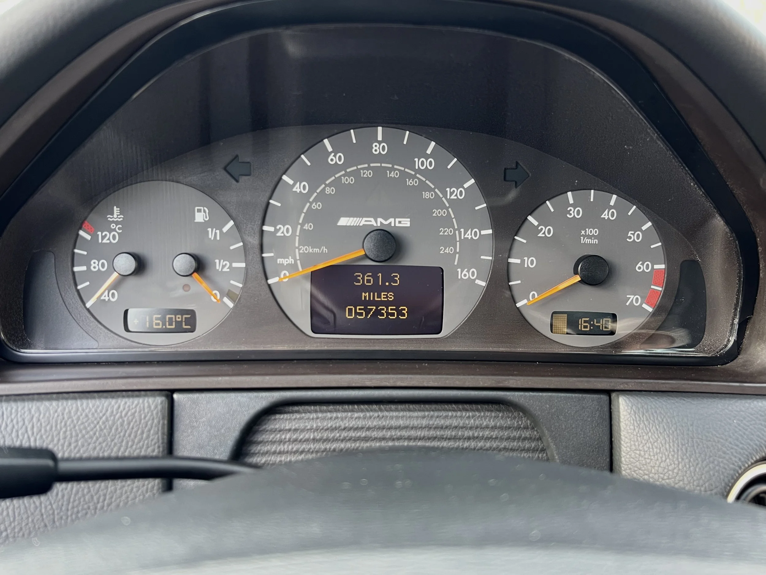 Dashboard of a car showing speedometer, tachometer, fuel gauge, and digital display with mileage and temperature readings.