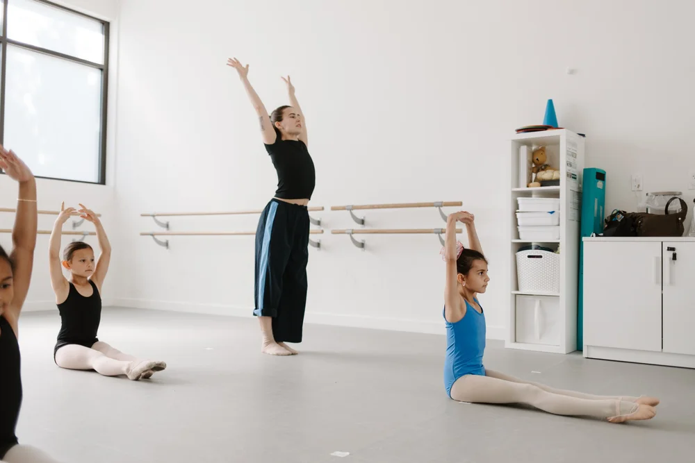 A teacher working with students at Neighborhood Ballet