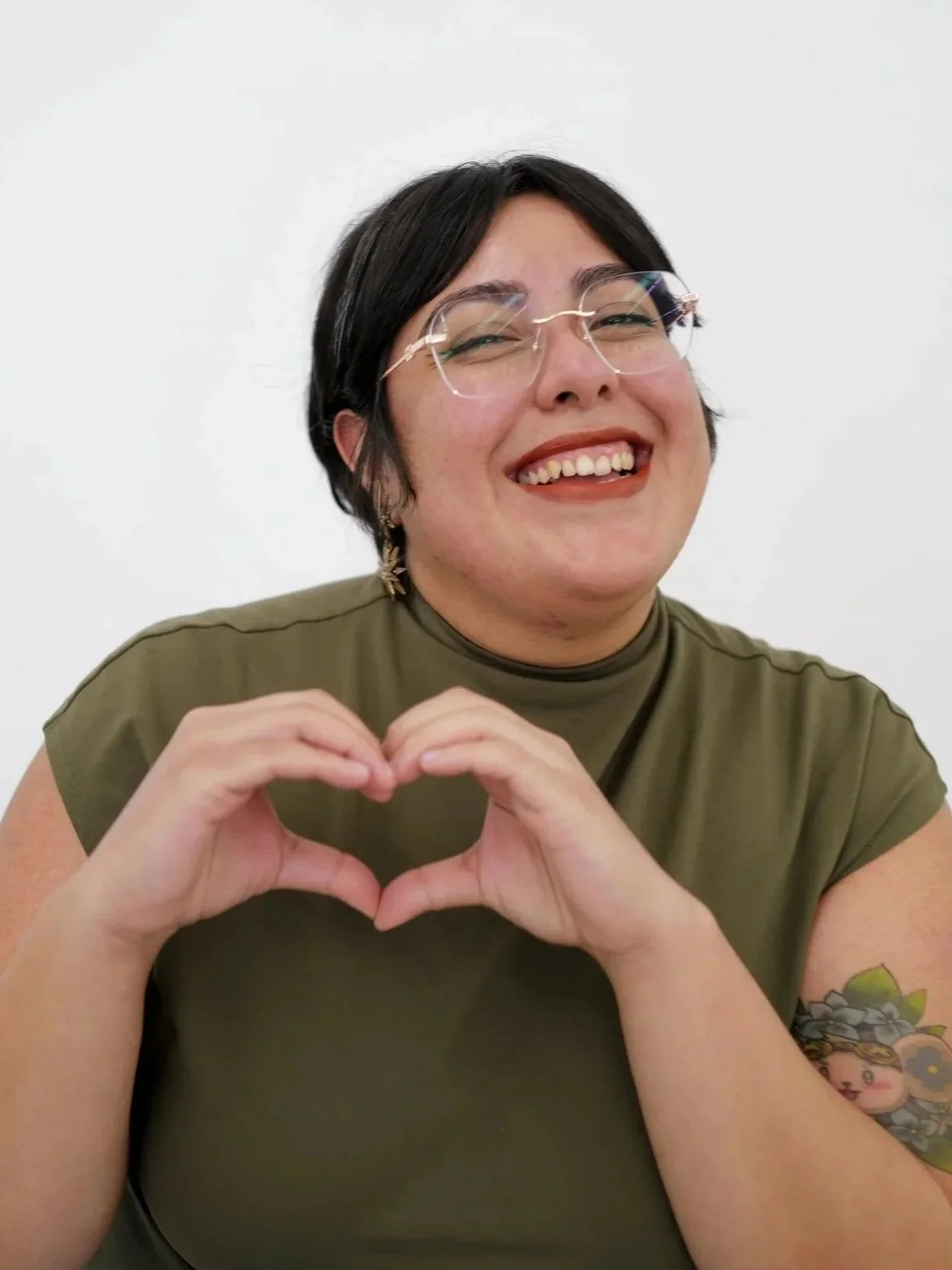 Mars Mata smiling holding heart hands