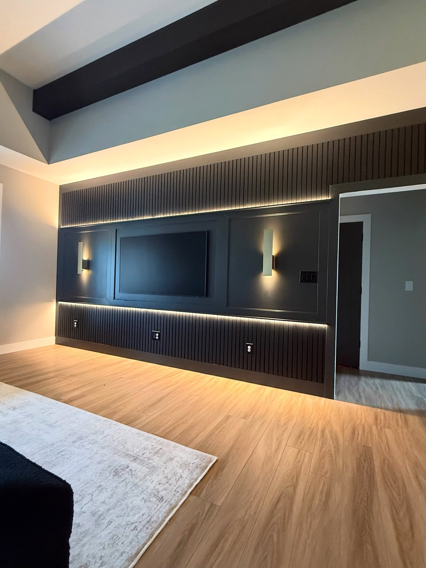 For this project, the customer had a vision they wanted for the media/accent wall in their new home. Greenline delivered! Custom trim work and lighting, finished off with a picture frame television and Sherwin Williams paint.