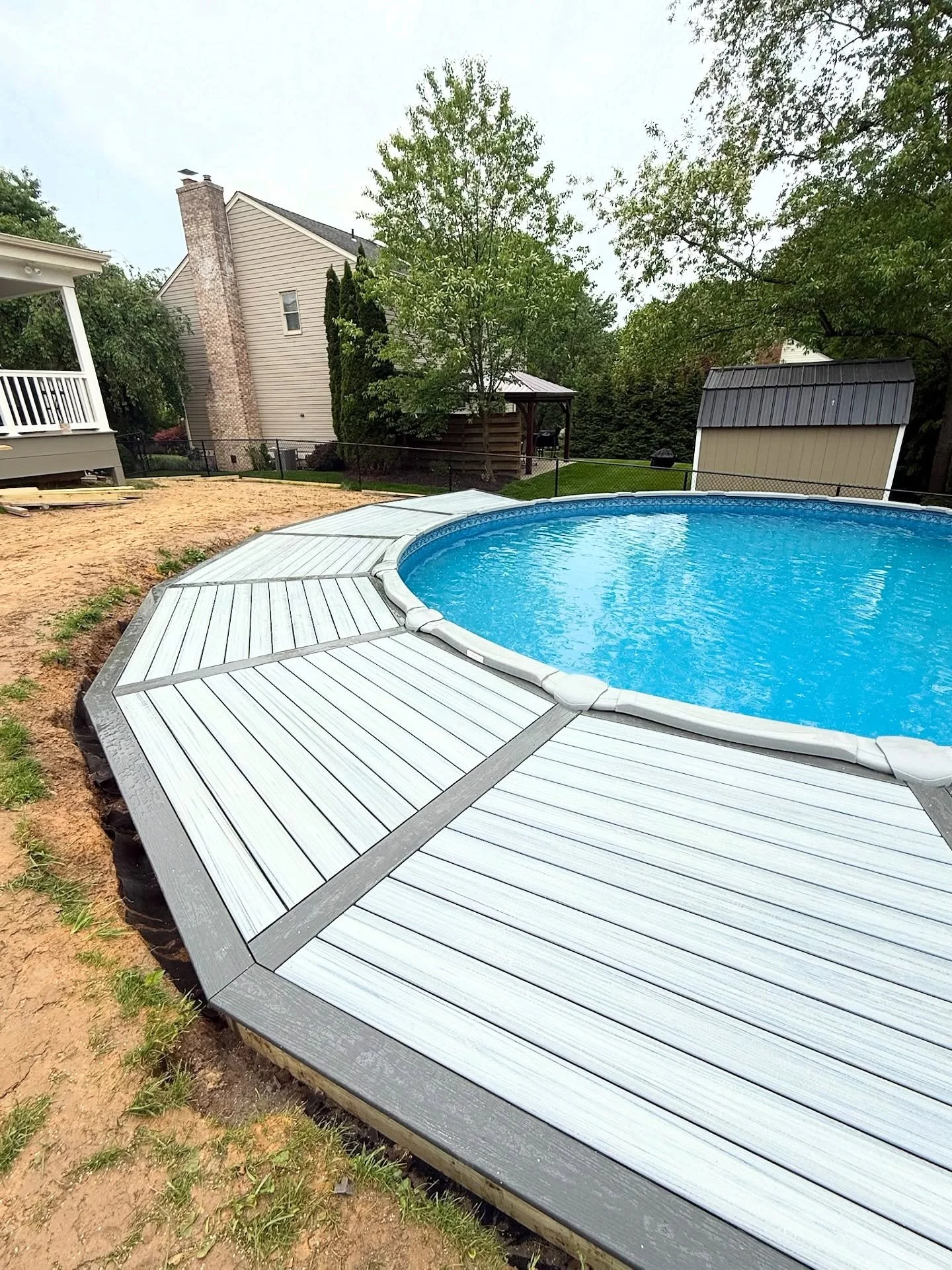New Deck &mdash; Santa brought our customer a new pool for their kids this year, so we were more than happy to add a composite, picture framed deck half way around it.