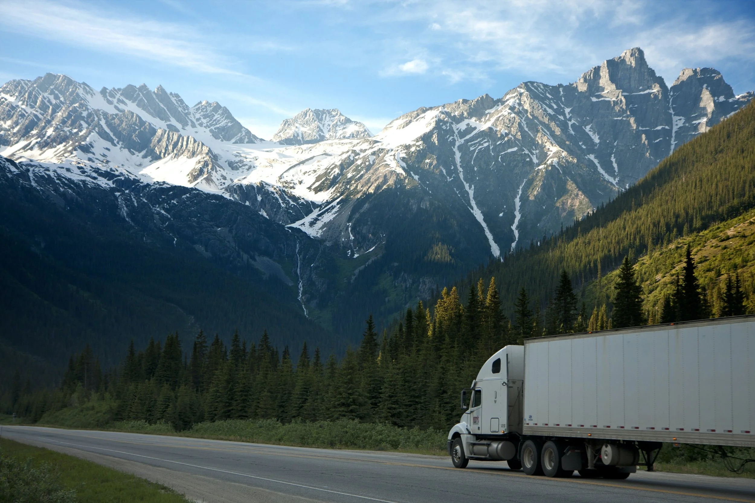 Large freight truck driving on a highway.