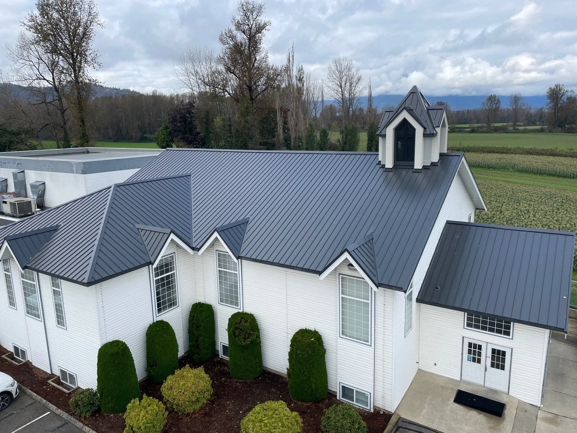 Commercial roofing installation completed by Top Notch Roofing in Chilliwack, featuring a standing seam metal roof on a commercial building in the Fraser Valley.
