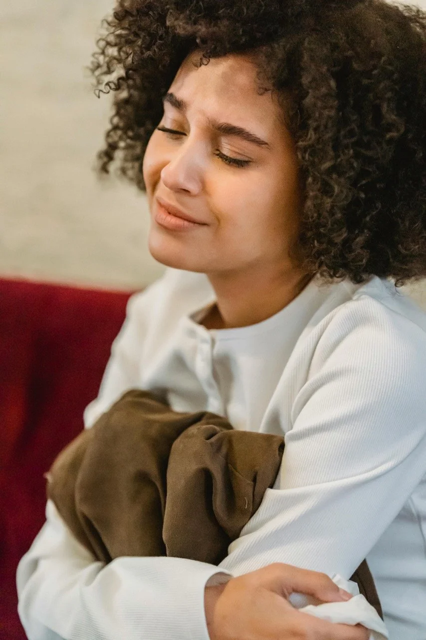 woman holding her stomach in pain