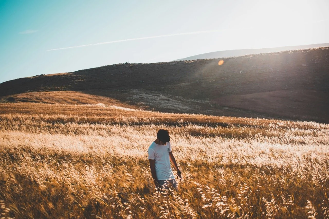 man walking in a field