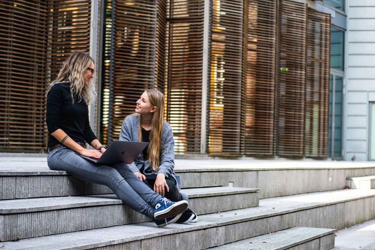 women talking on steps