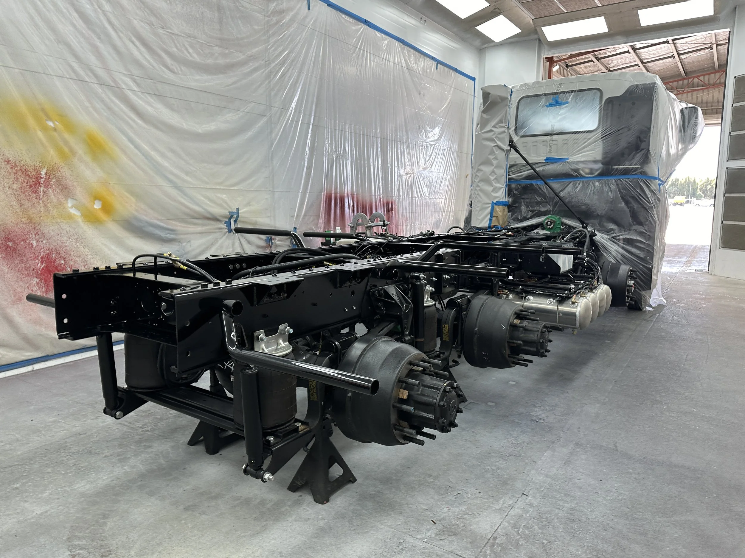 Industrial truck chassis in a workshop showcasing IGL Coatings for industrial and commercial applications. Provides superior protection against chemicals, corrosion, and environmental exposure, ensuring enhanced durability and performance