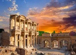Ancient ruins and the Parthenon on the Acropolis in Athens, Greece, illuminated at dusk.