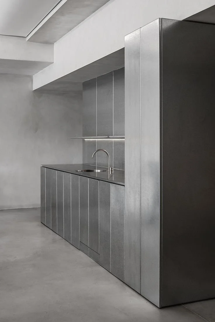 brushed metal finish and microcement surfaces