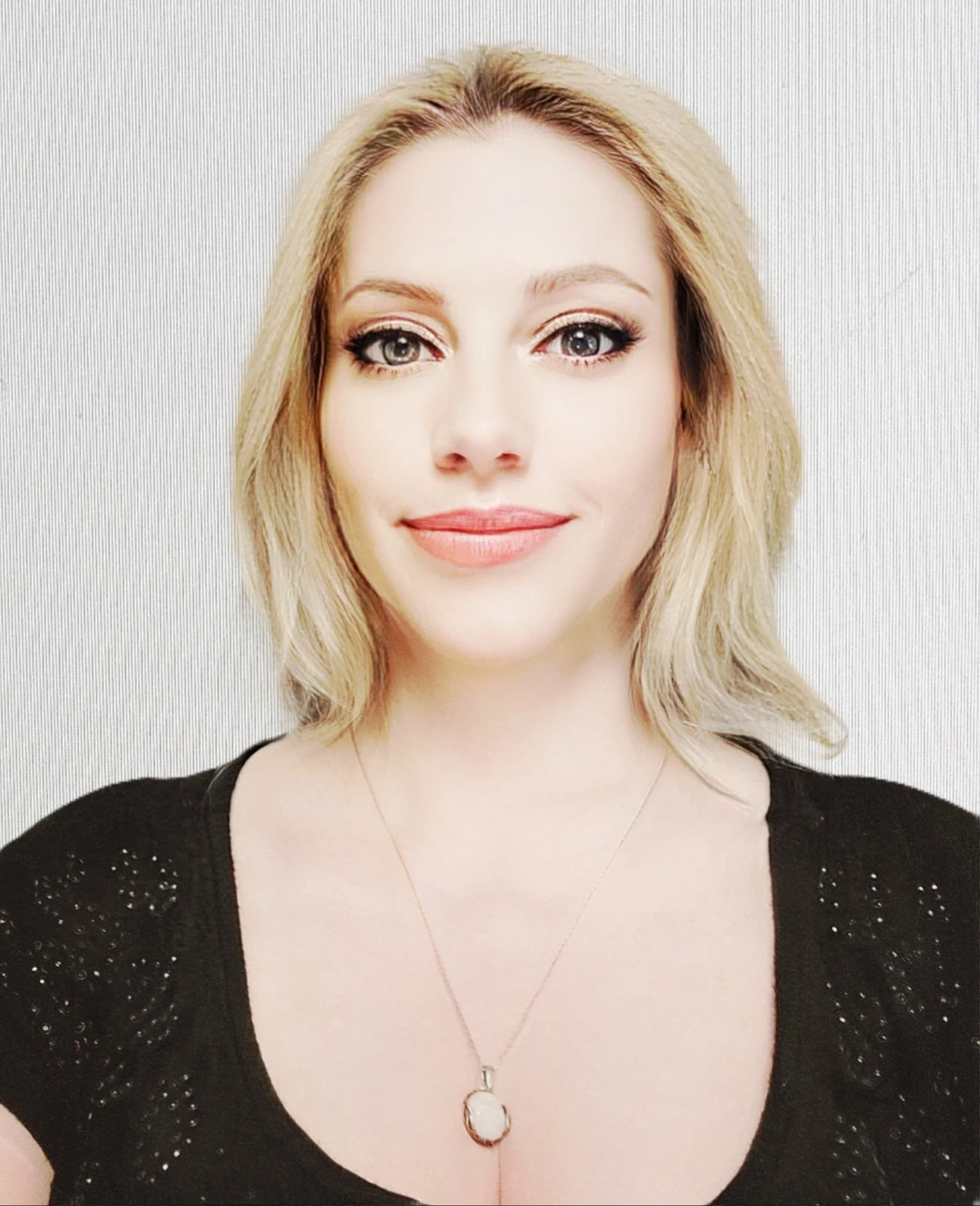 Portrait of a young blond woman with green eyes