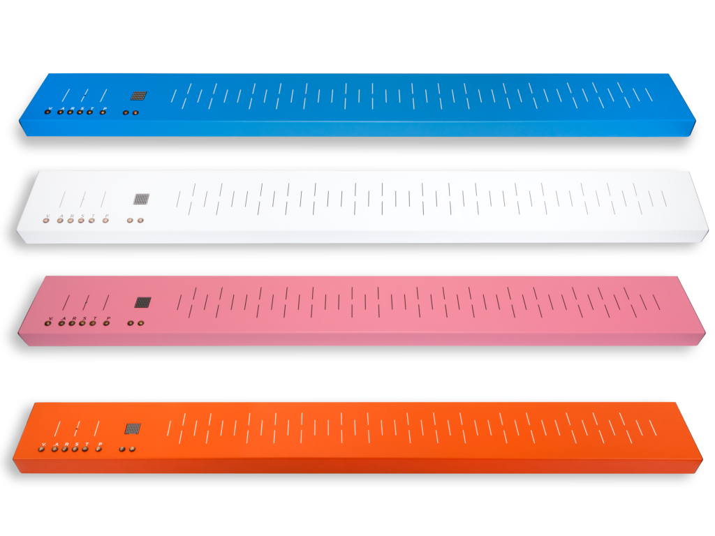 Four colorful mini electronic drum pads in blue, white, pink, and orange, each with multiple buttons, LEDs, and touch-sensitive pads for playing music.