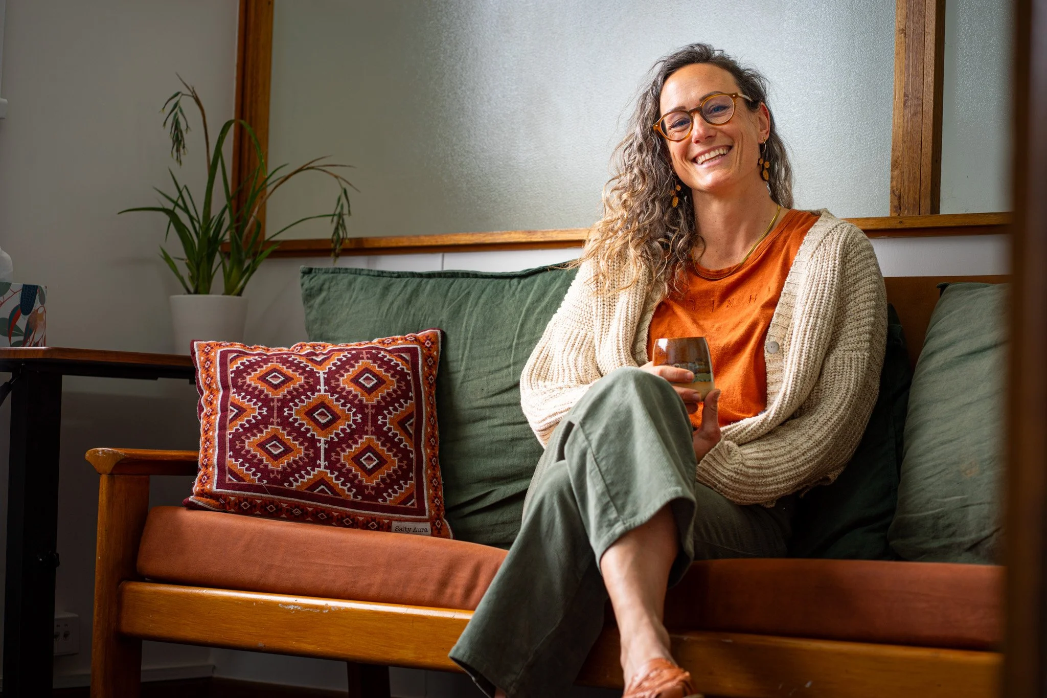 Therapist sitting on couch in mid century therapy office