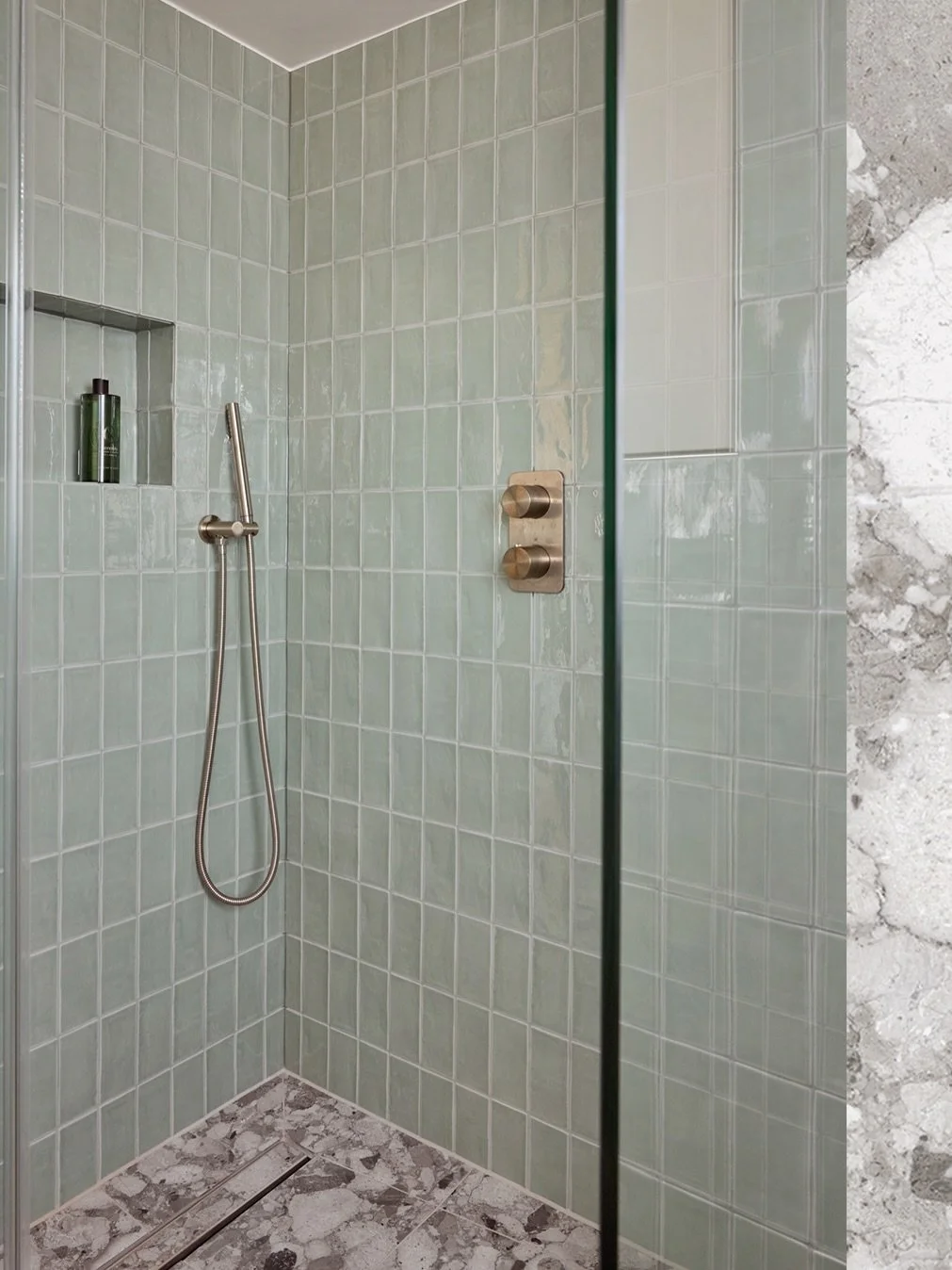 The starting point for this scheme was a soft green gloss tile that immediately caught our client&rsquo;s attention during the first design meeting. From there, the palette evolved into a calm, textural mix of muted tones and natural finishes. Brushe