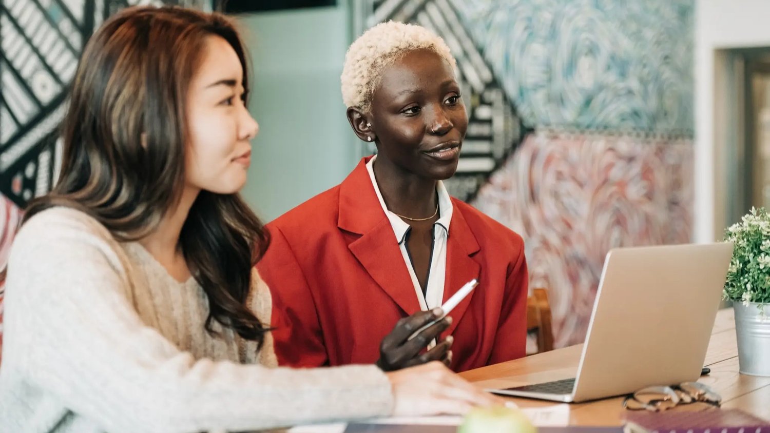 two recent graduates in a work meeting