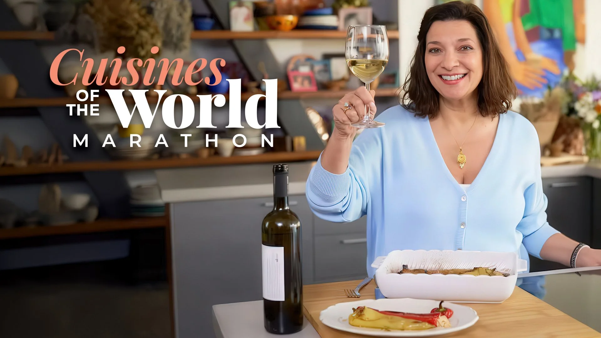 Diane Kochilas smiling and holding a glass of white wine