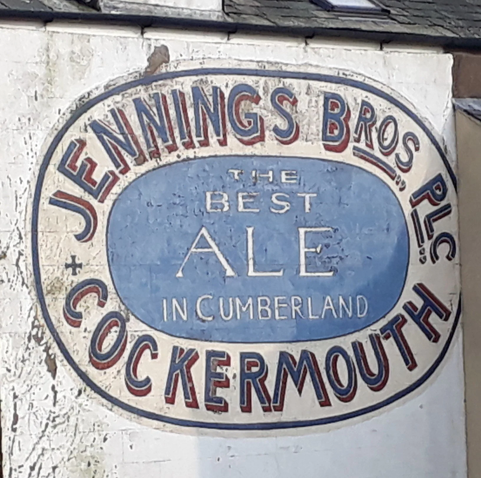 A vintage advert for Jennings Ale painted on the side of a house