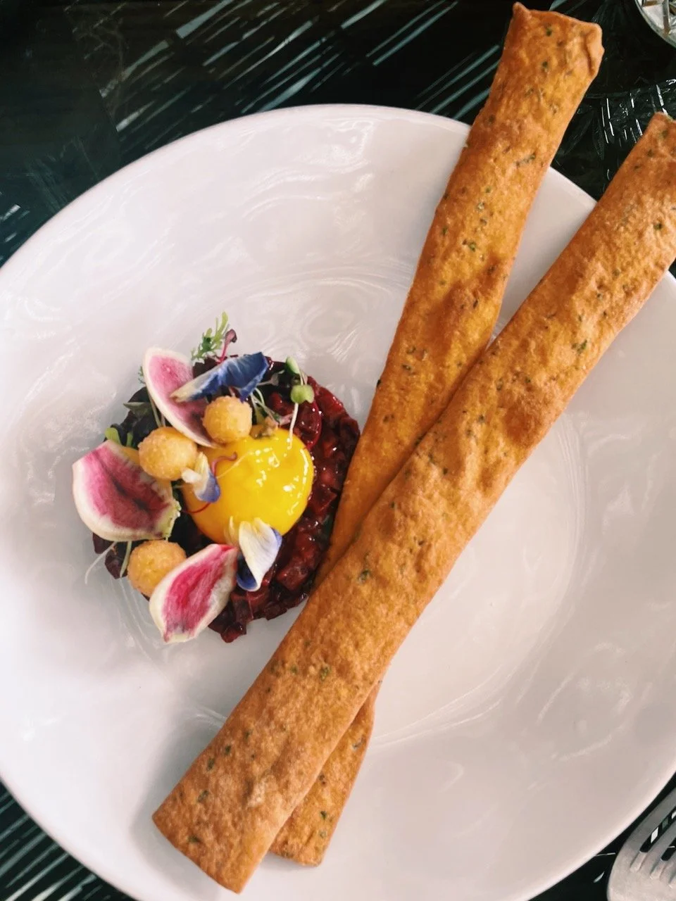 Beet ceviche with local edible flowers and house-made breadsticks. Almost too pretty to eat.