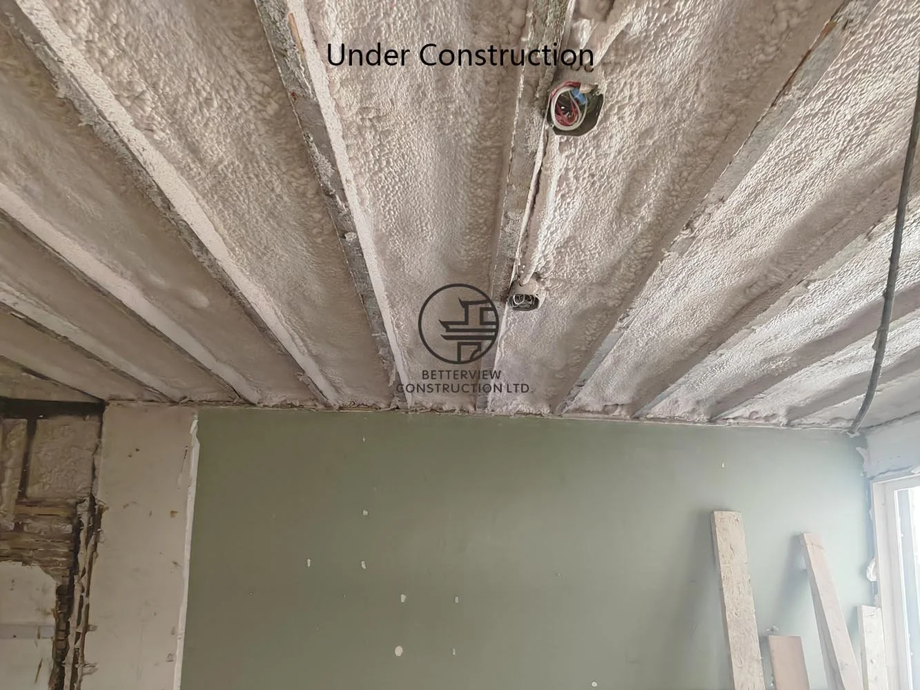 Spray foam insulation installed between floor joists to improve energy efficiency, thermal performance, and year-round comfort.