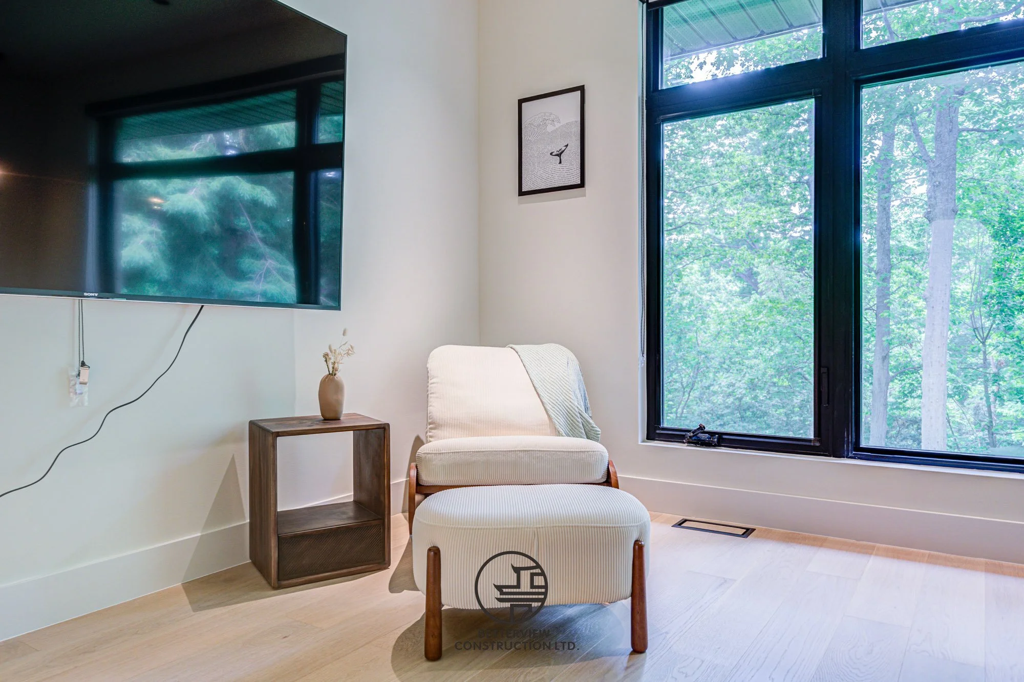 cozy seating corner in modern master bedroom with large window and natural light