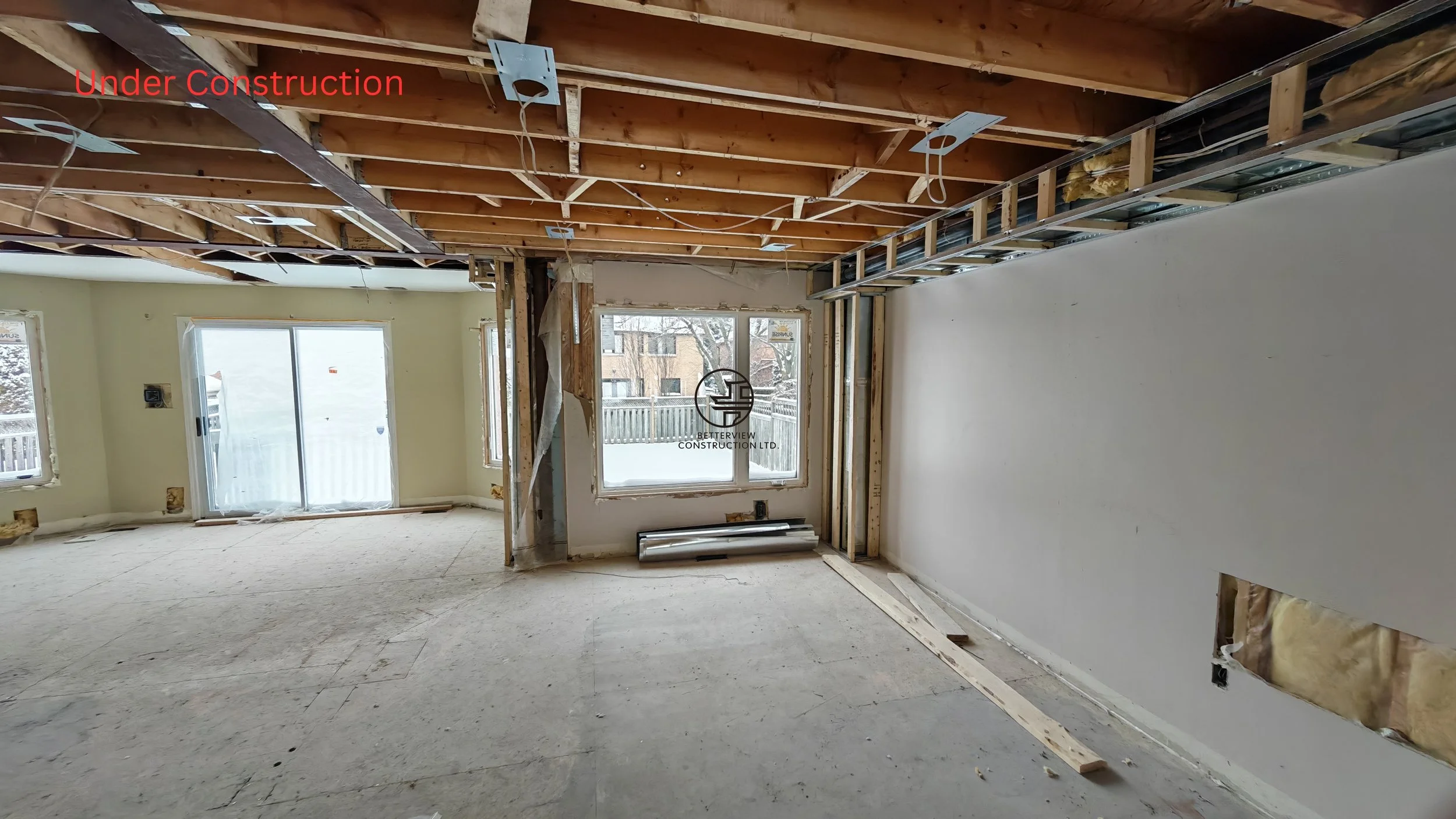 home renovation under construction with exposed ceiling framing open layout and structural modifications in residential interior demolition phase