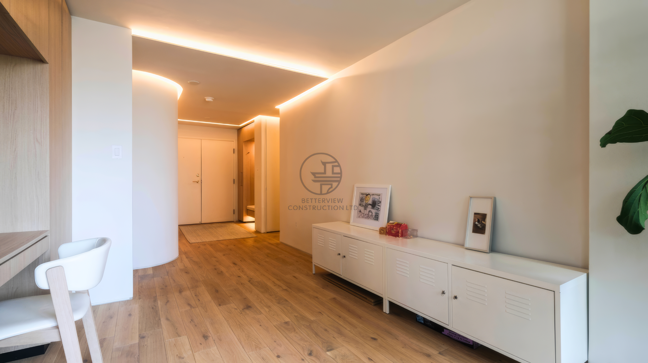 modern condo hallway with curved wall and LED ceiling lighting