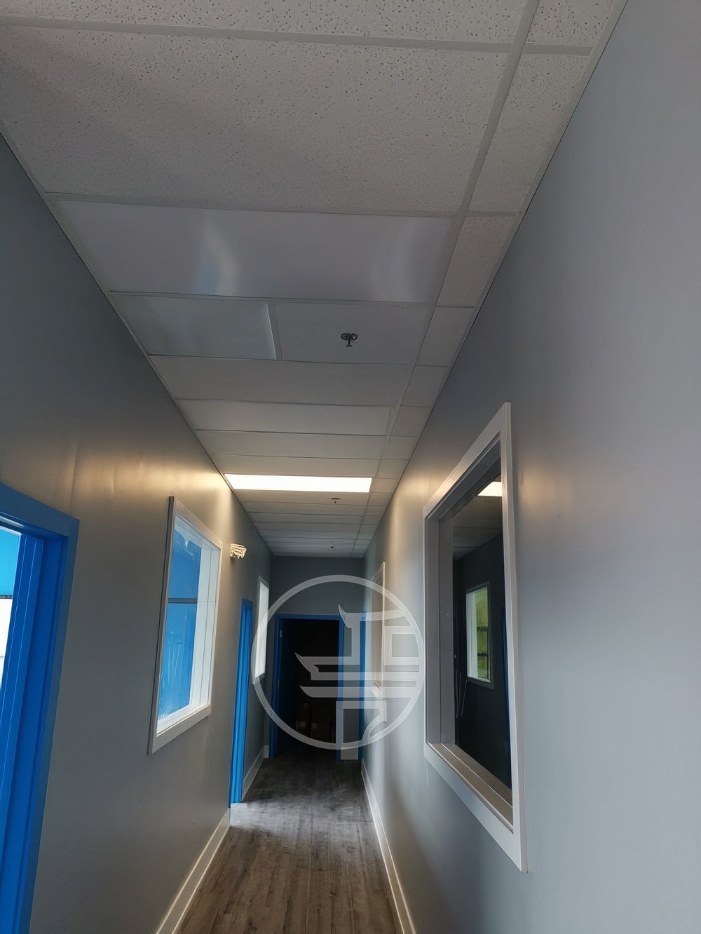 Commercial office hallway renovation in Toronto featuring finished corridor design, ceiling tiles, lighting, and modern interior finishes