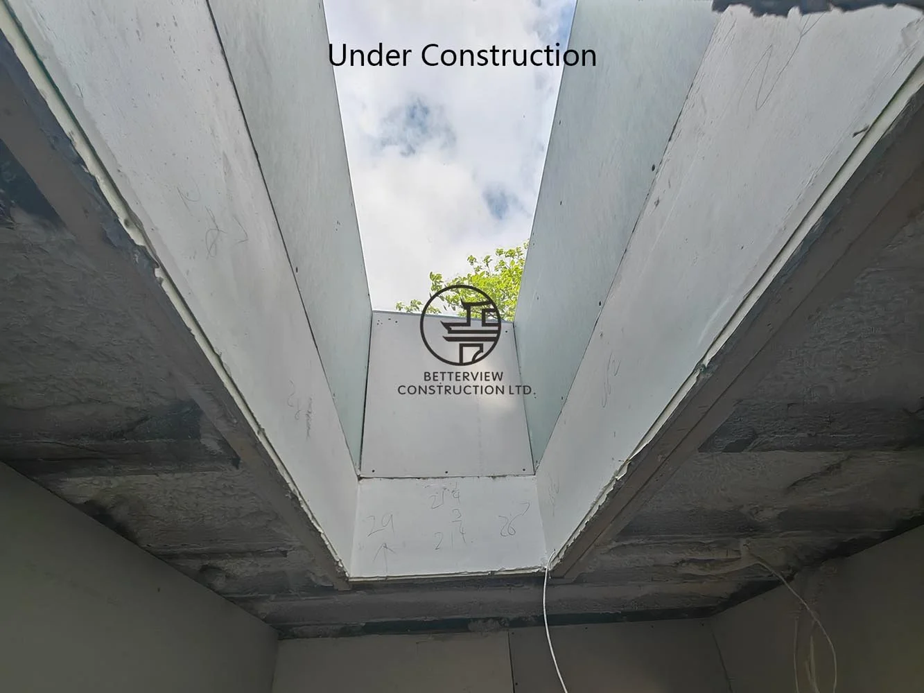 Large skylight shaft under construction, designed to bring abundant natural light into the open concept living space.