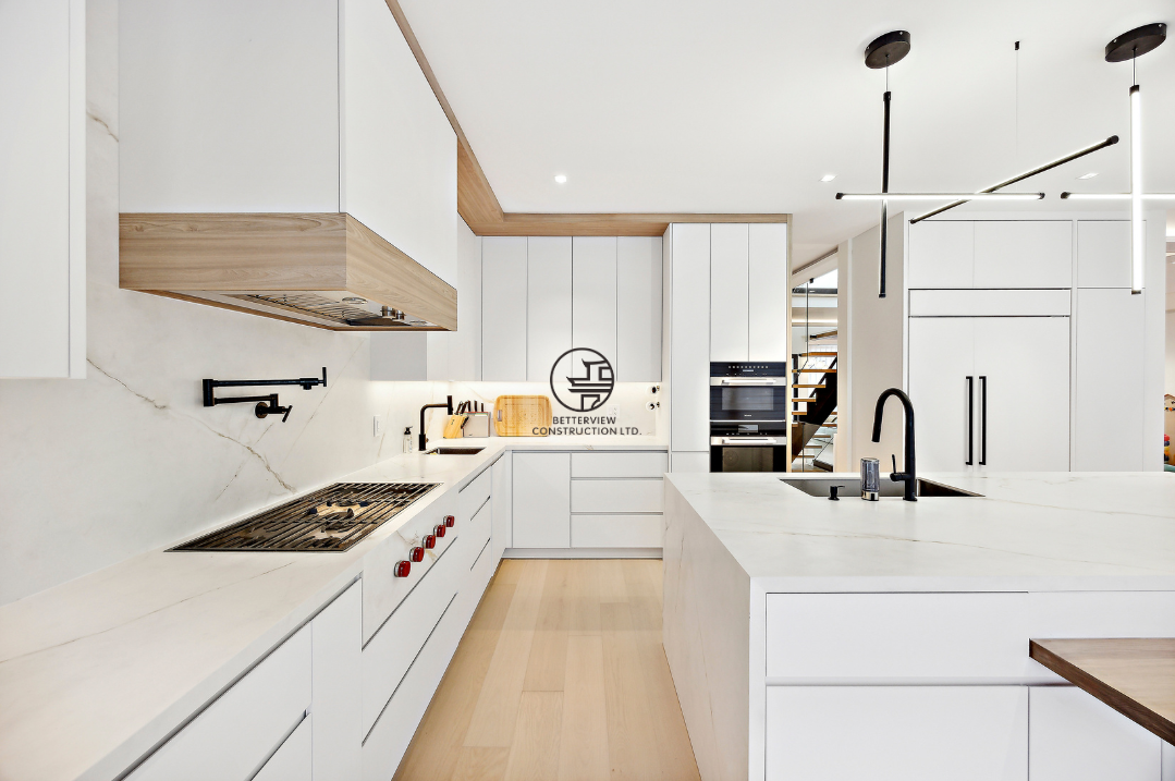 Modern white kitchen renovation featuring custom cabinetry, large central island, built-in appliances, and minimalist interior design in a GTA home