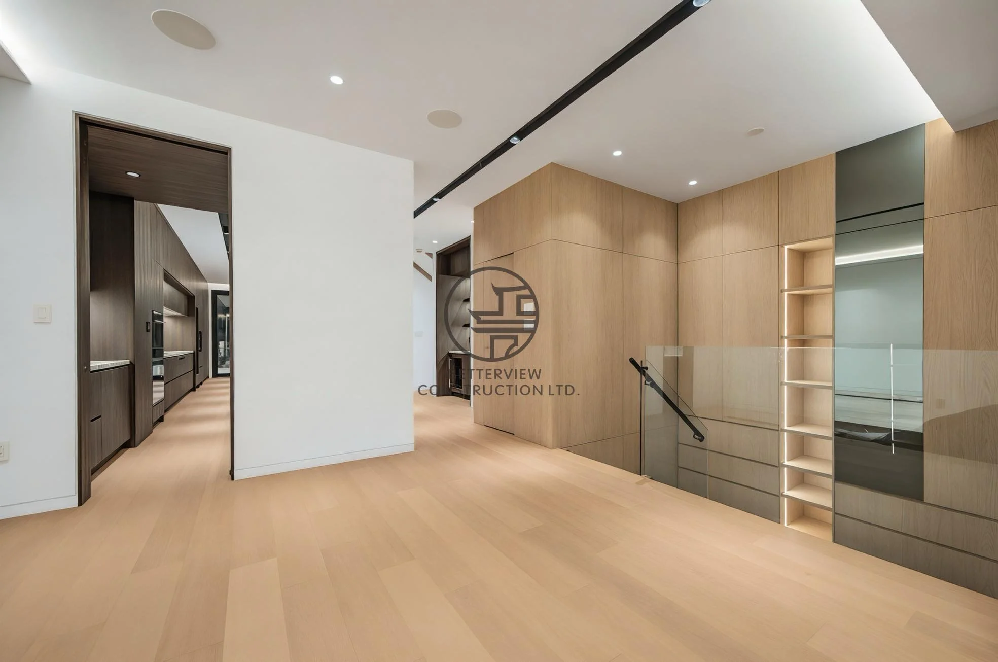 Modern home renovation in Toronto featuring open-concept layout, light wood flooring, custom wood paneling, and glass stair railing.