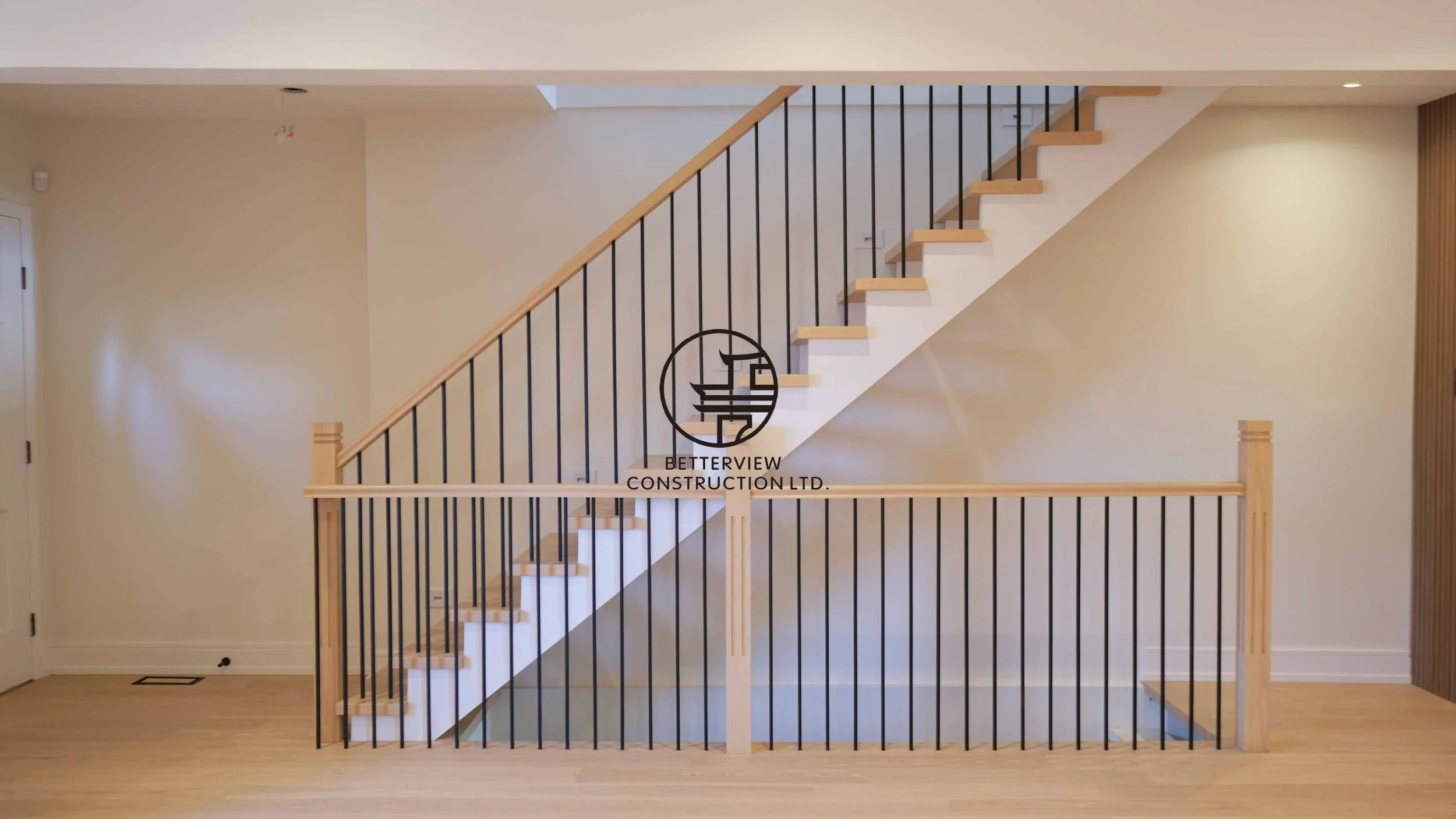 Contemporary wood staircase crafted and installed by Betterview Construction Ltd., highlighting rich natural timber finishes, seamless detailing, and refined modern design.