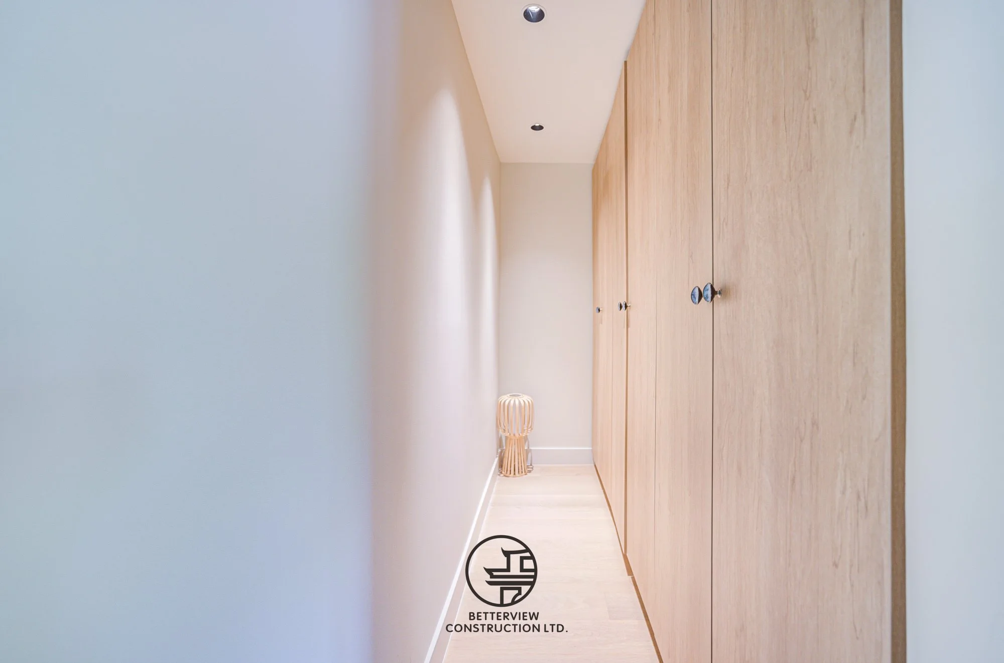 minimalist hallway with built in wood storage cabinets in renovated home