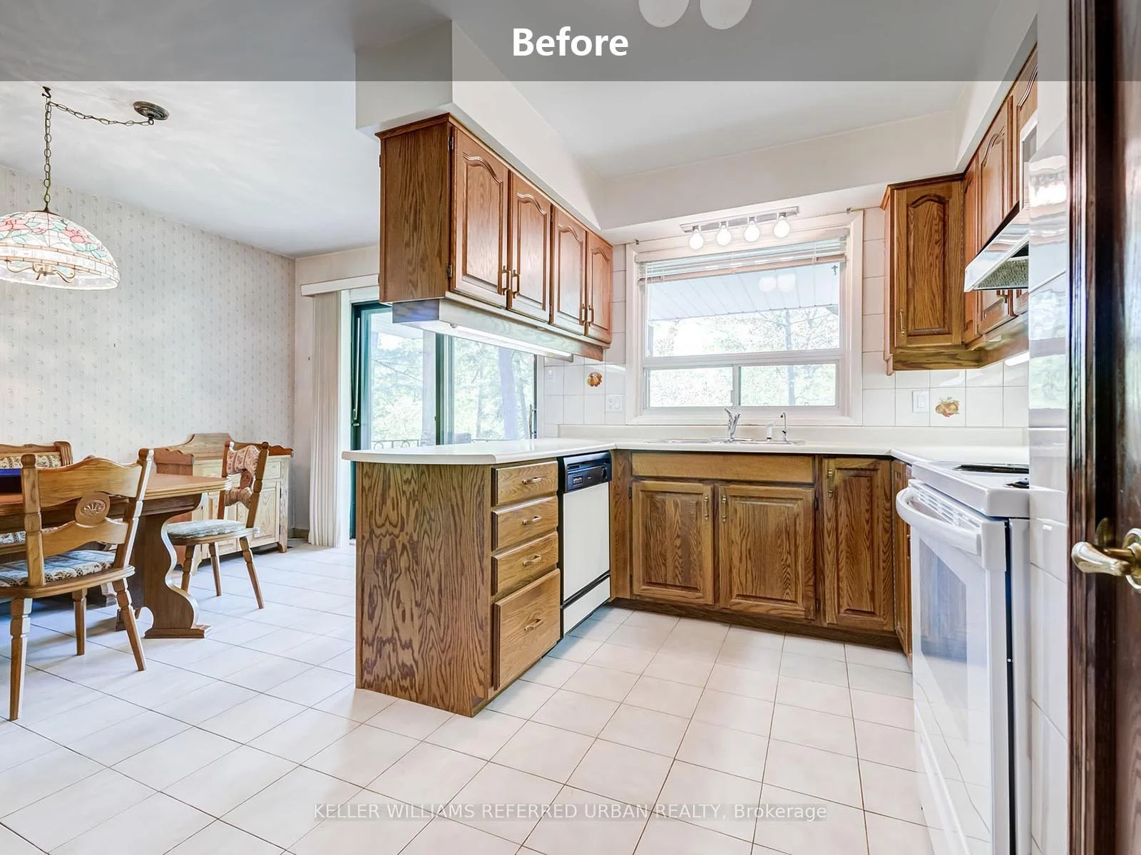 An older kitchen before remodeling, showcasing original cabinetry, dated finishes, and a traditional layout.