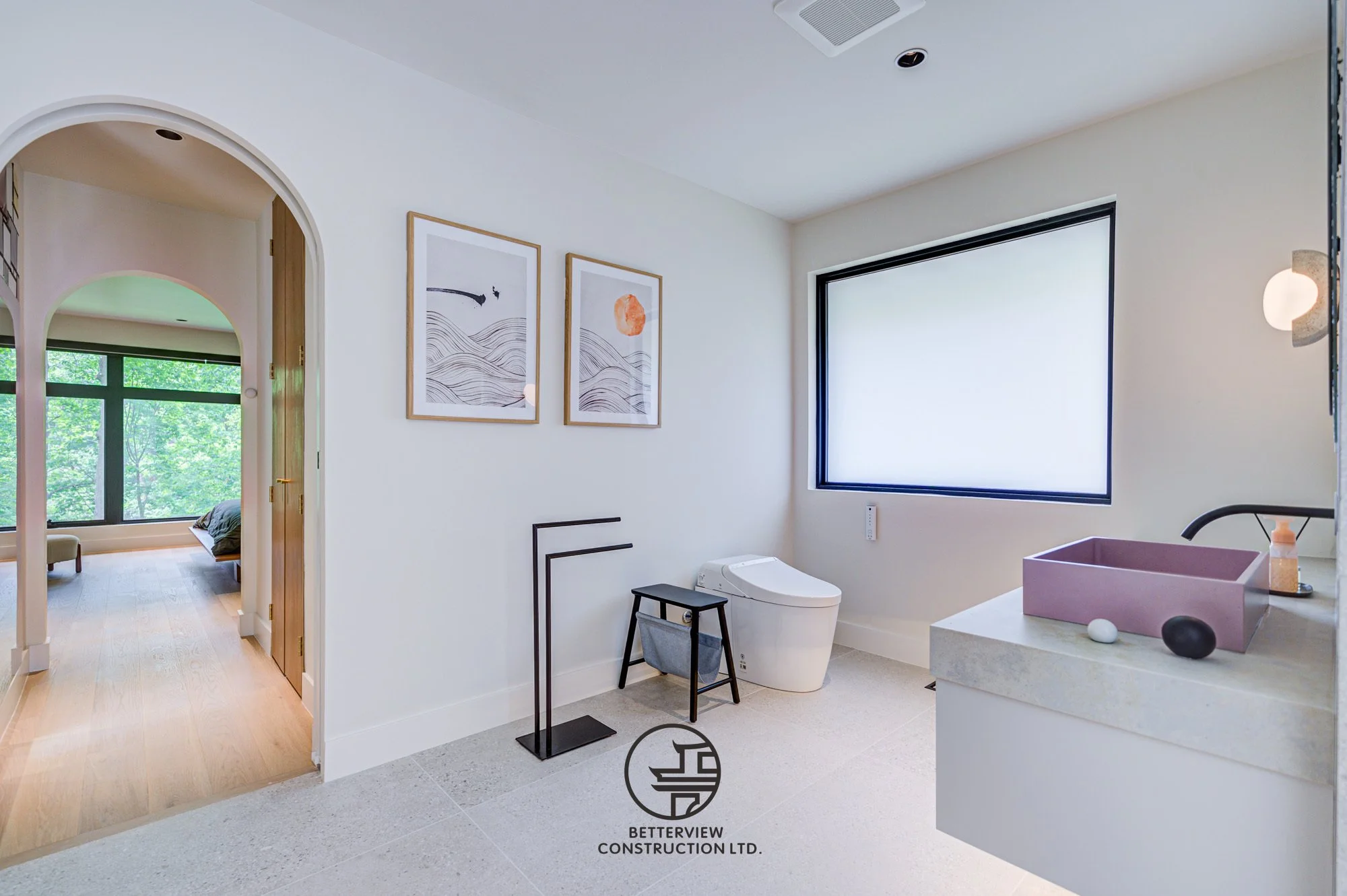 modern bathroom with arched doorway leading to bedroom in home renovation