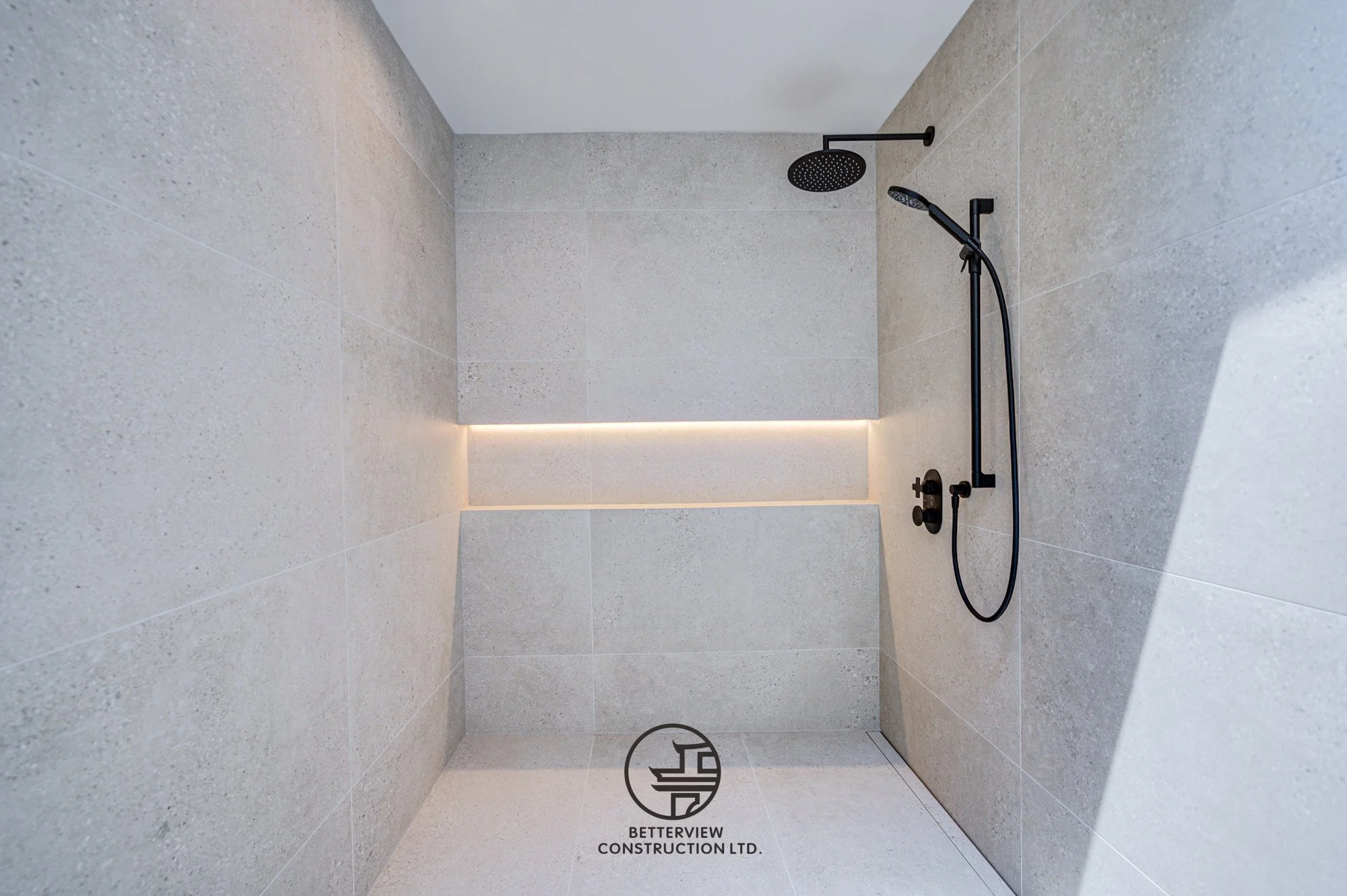 modern walk in shower with rainfall shower head and built in niche