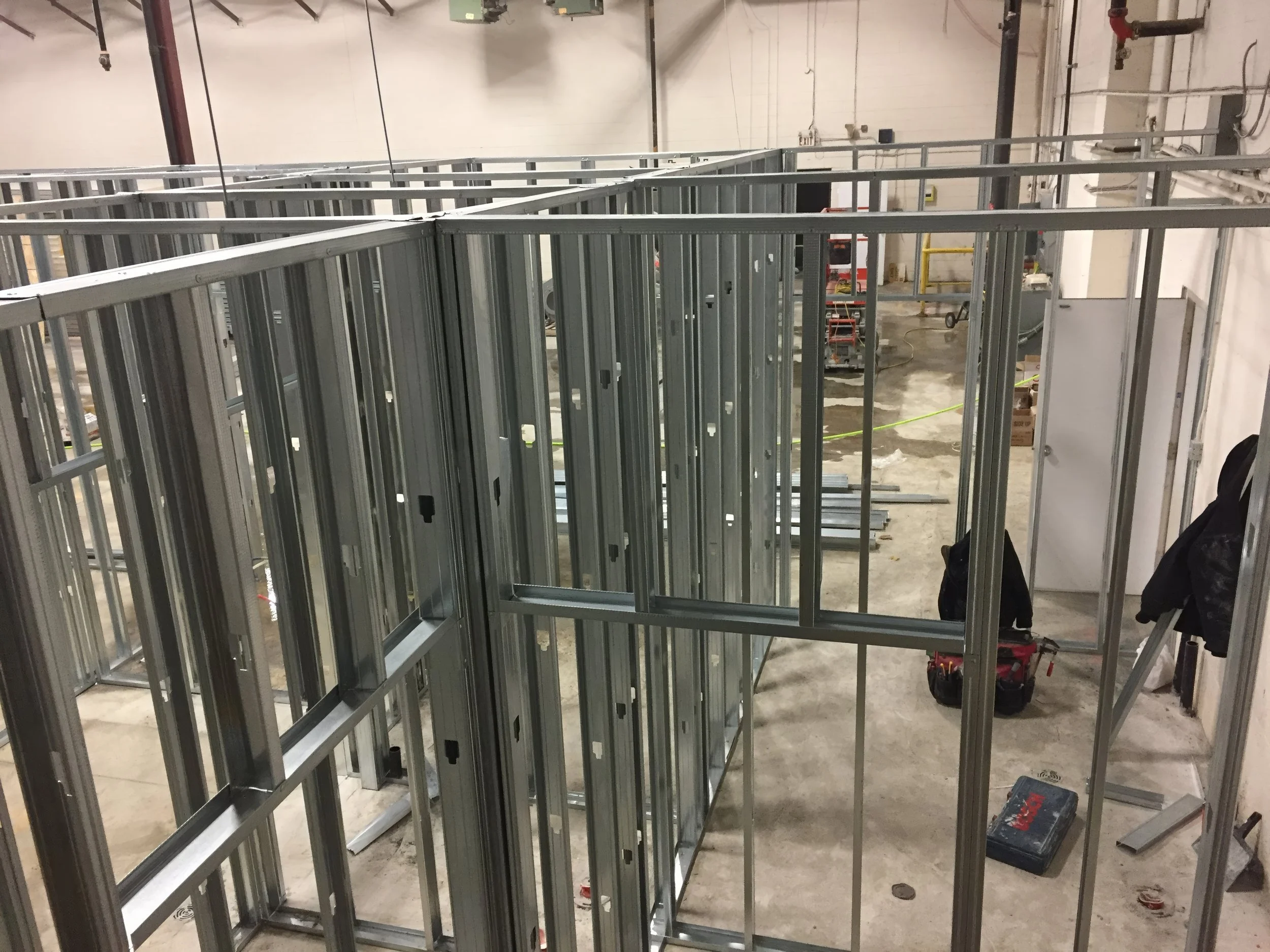 Commercial interior build-out showing steel stud framing with defined room layout for office or retail renovation in Toronto