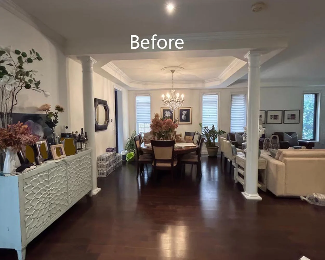 living and dining area before renovation with dark hardwood flooring traditional layout and columns in Toronto home interior
