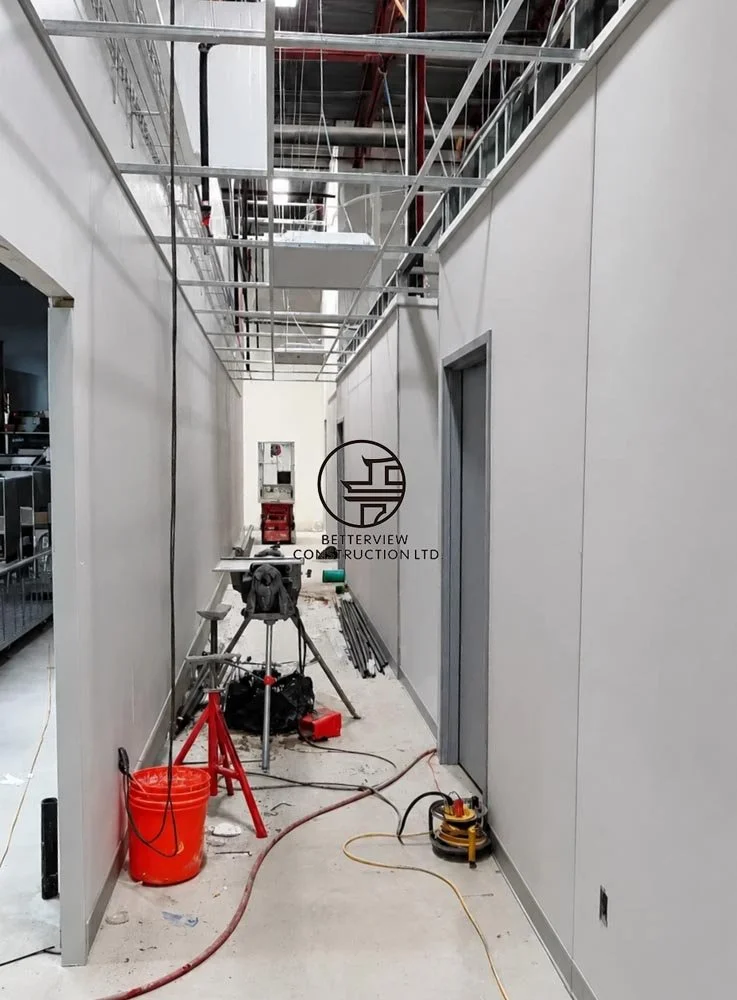 commercial-interior-corridor-construction-active-renovation-drywall-ceiling-work-toronto.jpg
