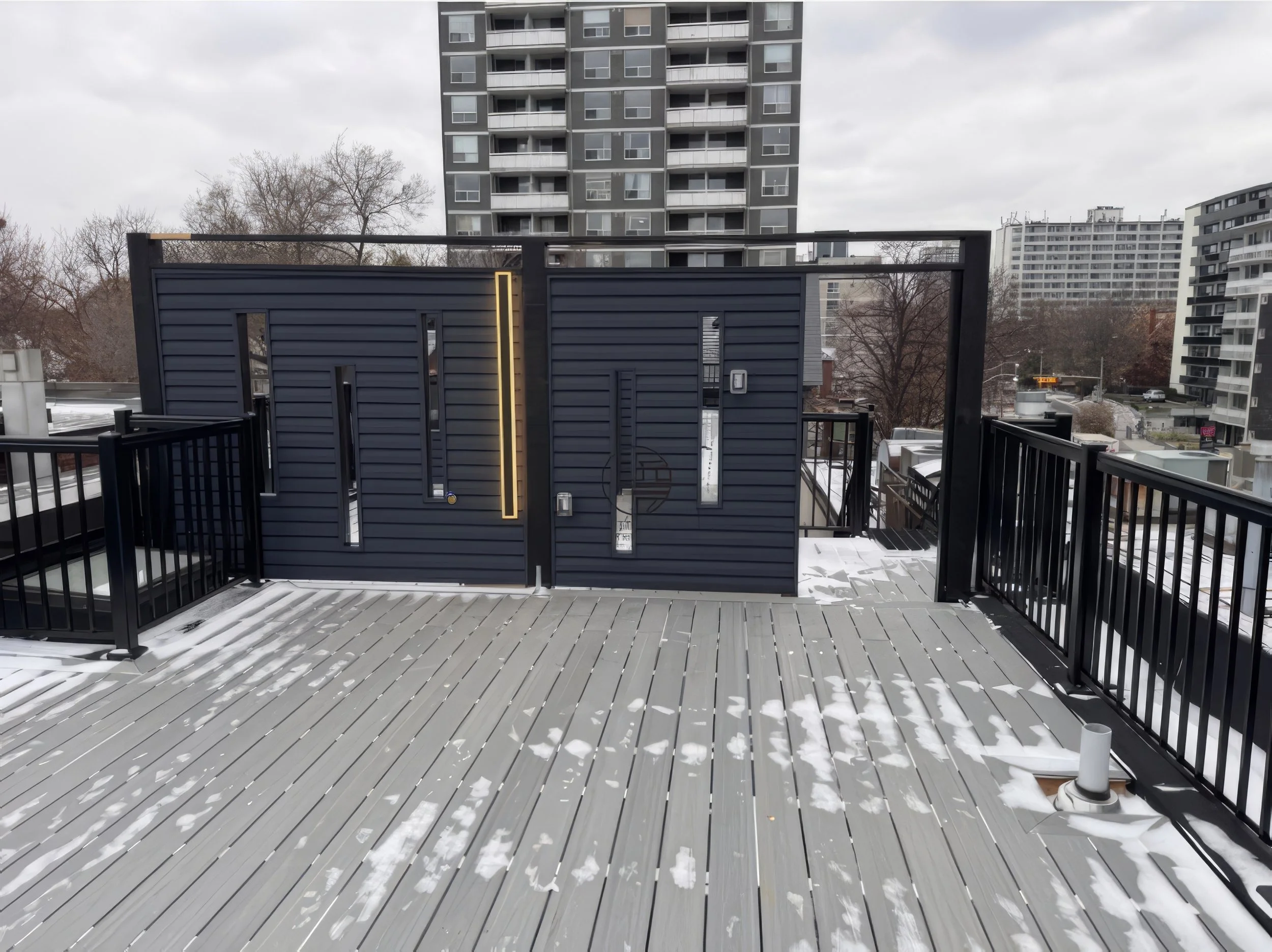 modern rooftop deck renovation with privacy wall, LED lighting, and composite decking in winter