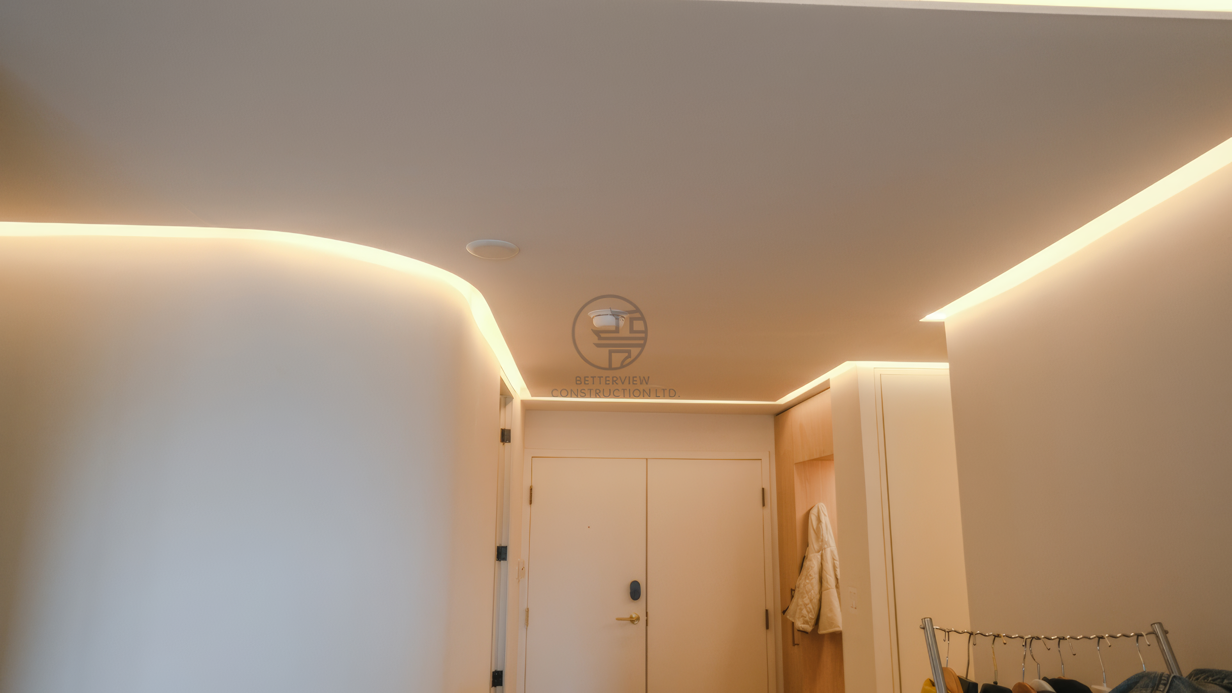 modern hallway ceiling with curved design and LED strip lighting