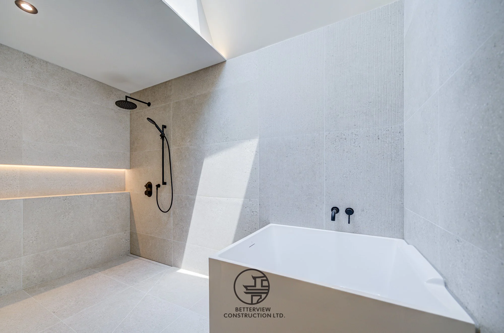 modern walk in shower and bathtub in minimalist bathroom renovation