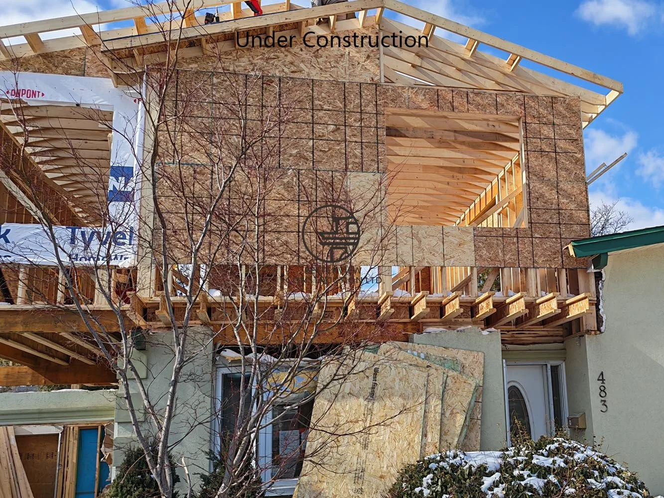 Second floor home addition framing with exterior structural wood construction for a custom house expansion project in Toronto.