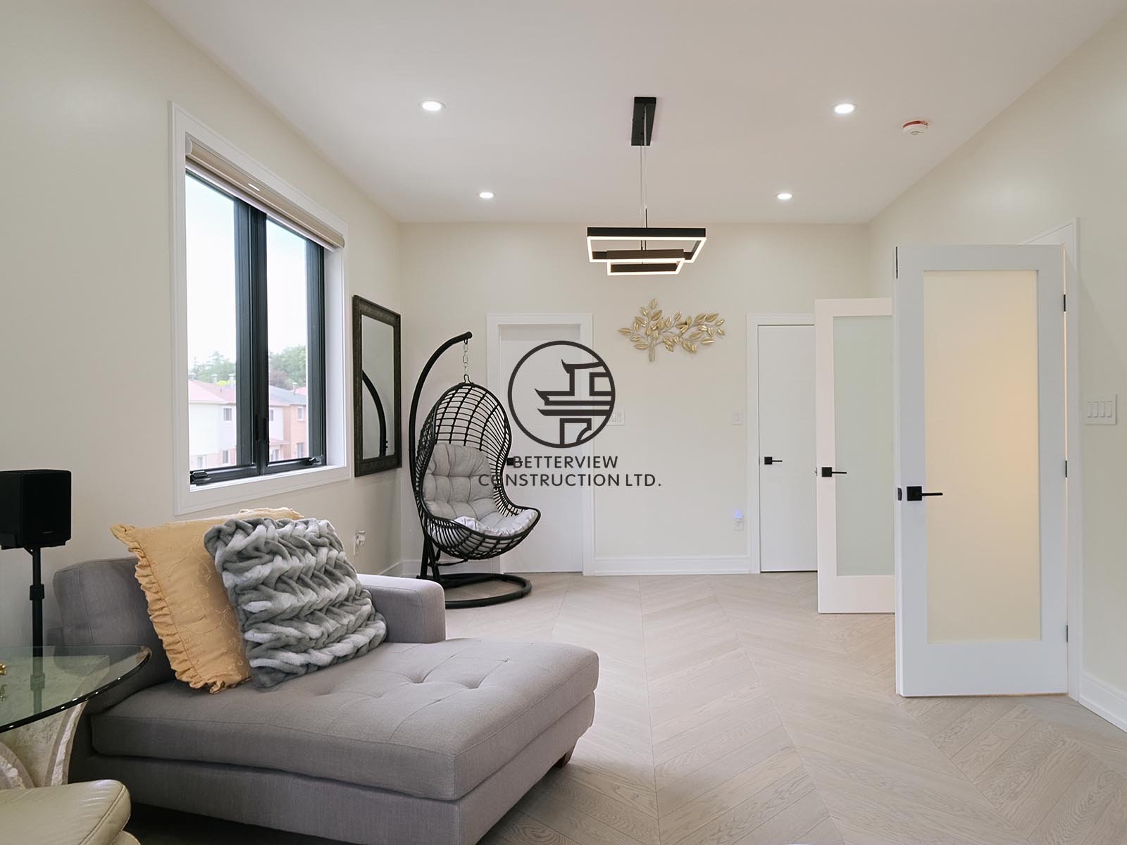 This modern home addition creates a bright and spacious secondary living area with large windows, contemporary finishes, and an open layout. The thoughtfully designed addition seamlessly extends the home's living space while maximizing comfort and fu