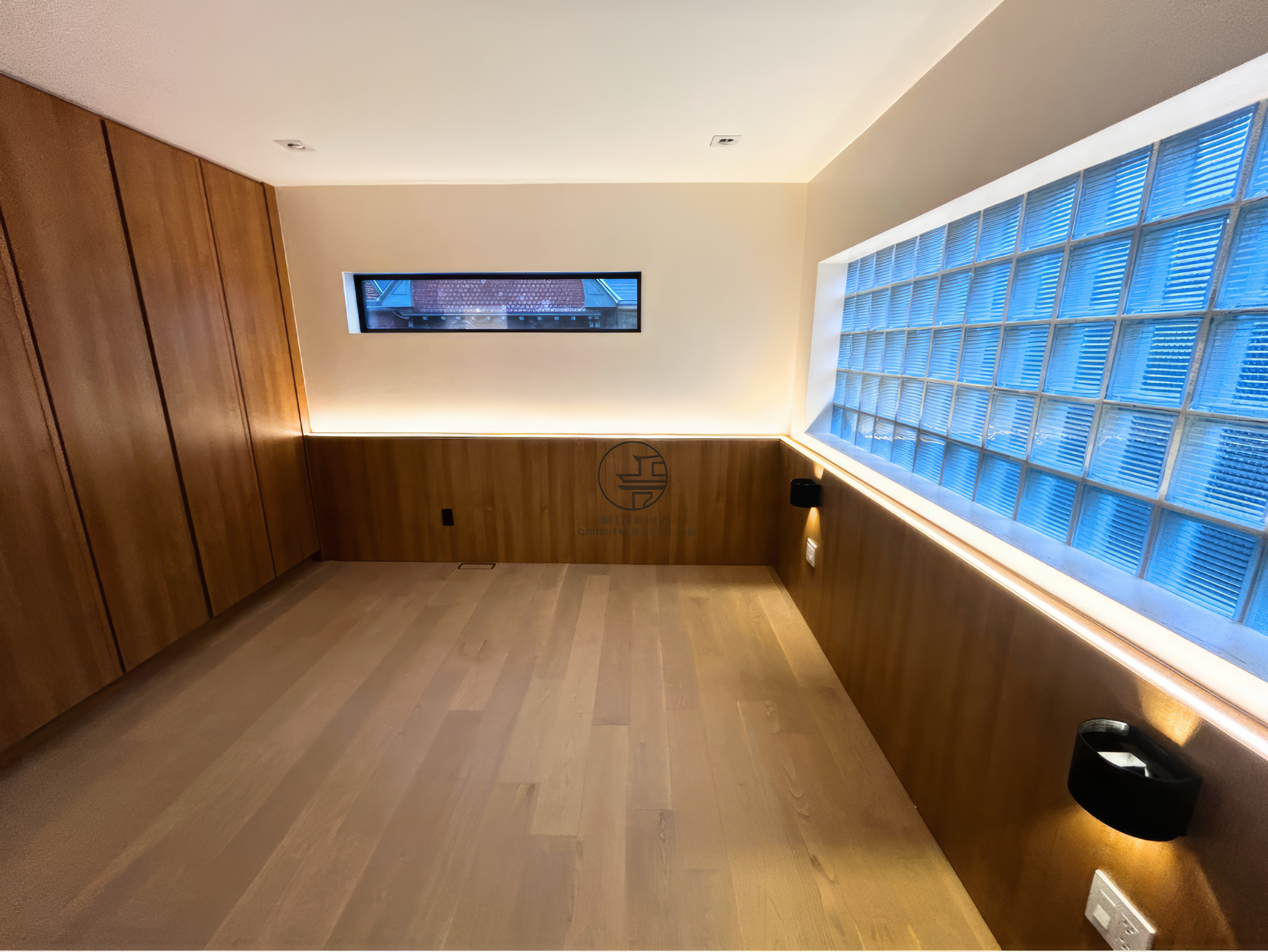 modern basement renovation with wood panel walls, glass block window, and ambient LED lighting